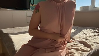 A Dainty Woman In A Pink Dress Indulges In Some Self-Pleasure